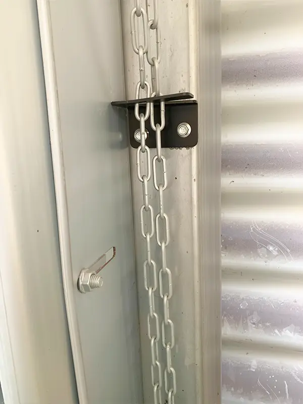 Close-up of the manual chain hoist mechanism for emergency garage door operation during power outages.